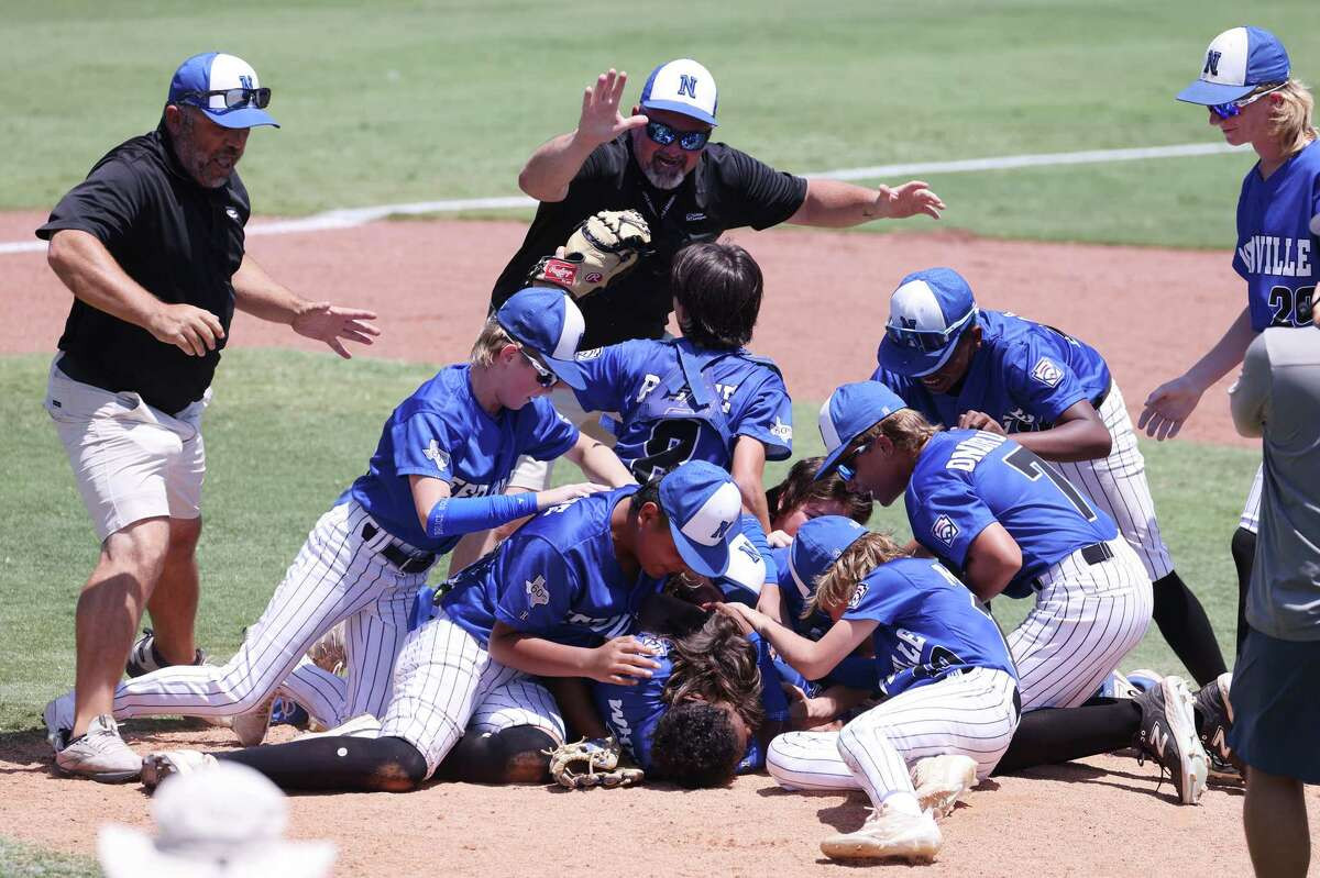 Picture of Little League boys mobbed at the mound in celebration of win (Rod Aydelotte)